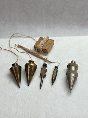 Lot of 5 Assorted Plumb Bobs with Gold and Silver Finishes.